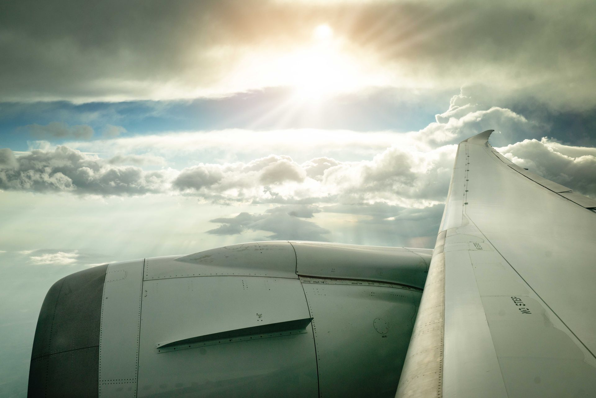 View of an aircraft wing above the clouds at sunrise