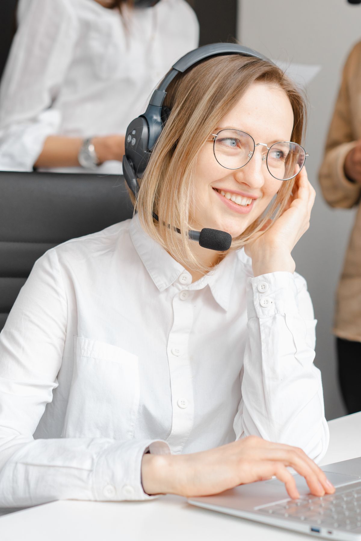 A reservations agent wearing a headset at a support desk